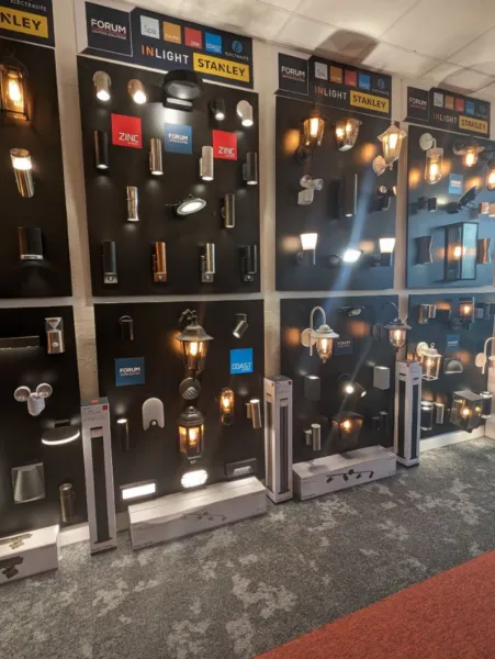 Showroom wall of black display boards with outdoor wall lights, lanterns and spotlights from Forum, Zinc, Inlight and Stanley